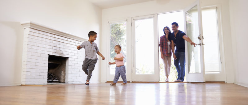 Family with kids walking into empty home